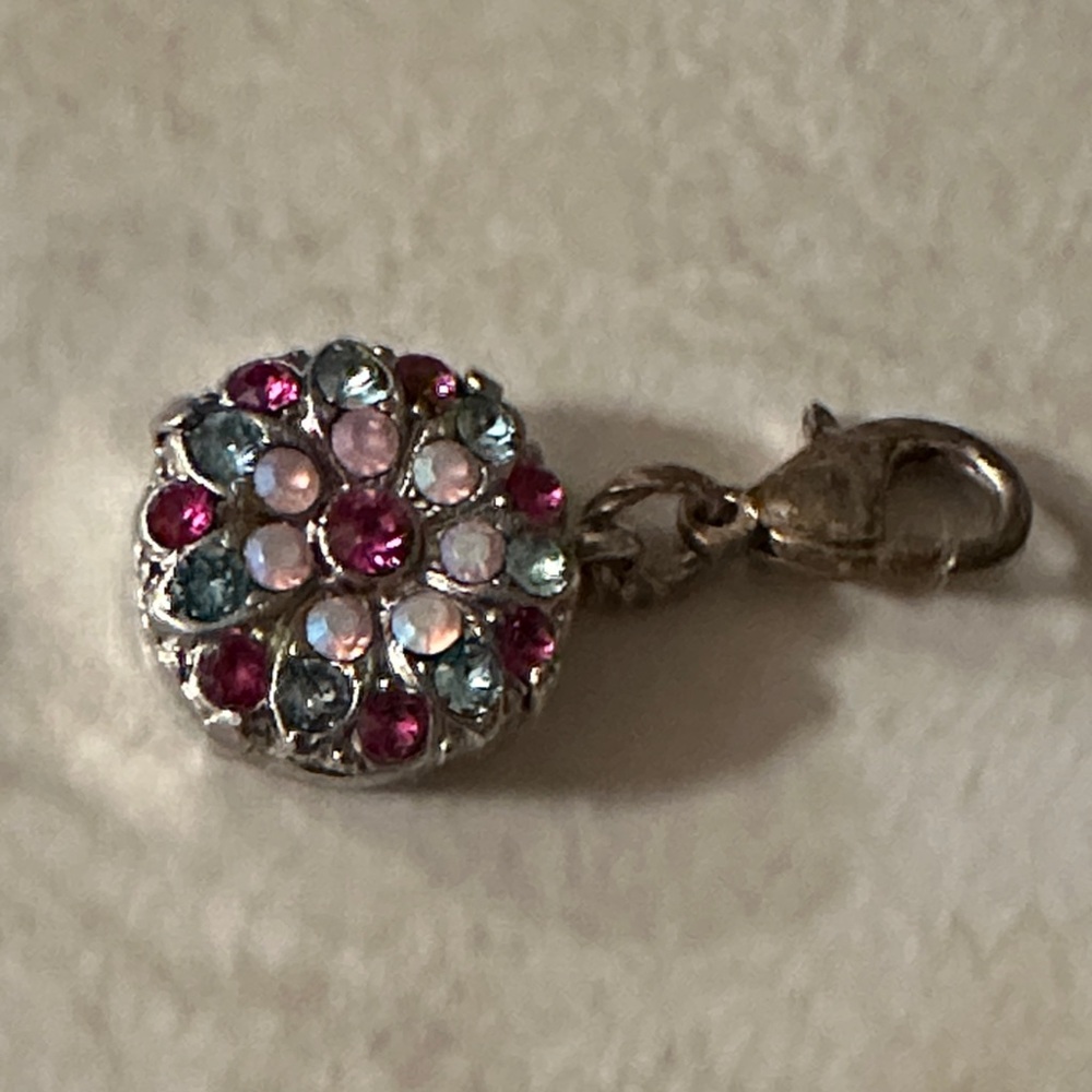 Pretty colors of pinks and blue set in silver tone.   Such a cute piece!